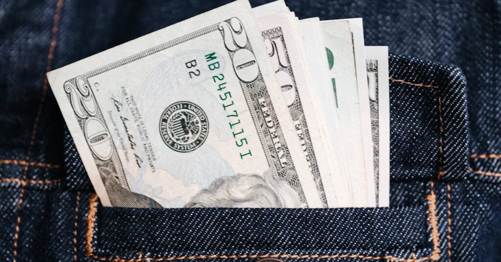 Close-up of US dollar bills in a denim jacket pocket, symbolizing wealth and finance.
