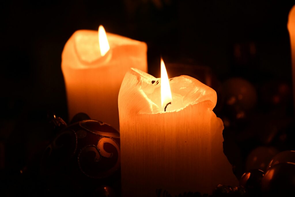 Warm and inviting close-up of burning candles, creating a cozy atmosphere.